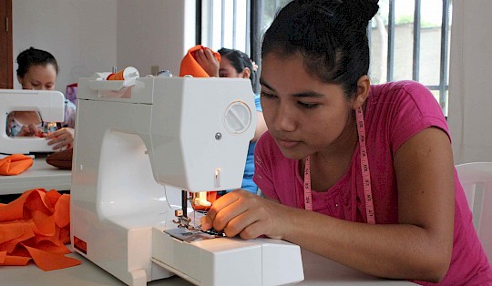 A woman in training to become a seamstress.