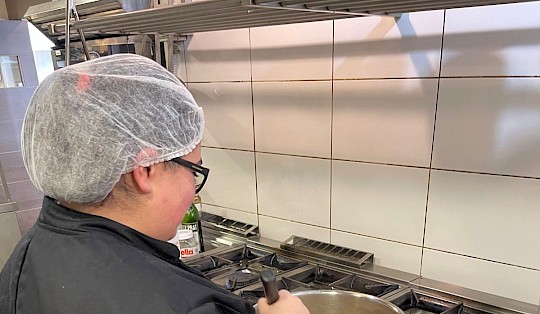 A women cooking as a part of her vocational training.