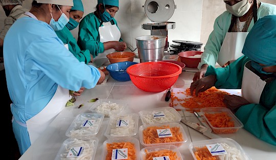 Before being sold, the agricultural products grown by the women are cut and packaged.