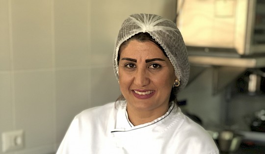 A catering student ready for to present her final products.