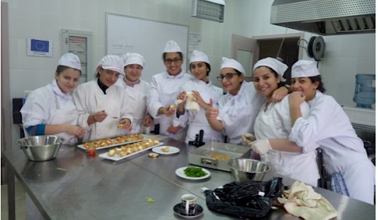 The teacher with their students preparing different types of dishes in the Cooking workshop.